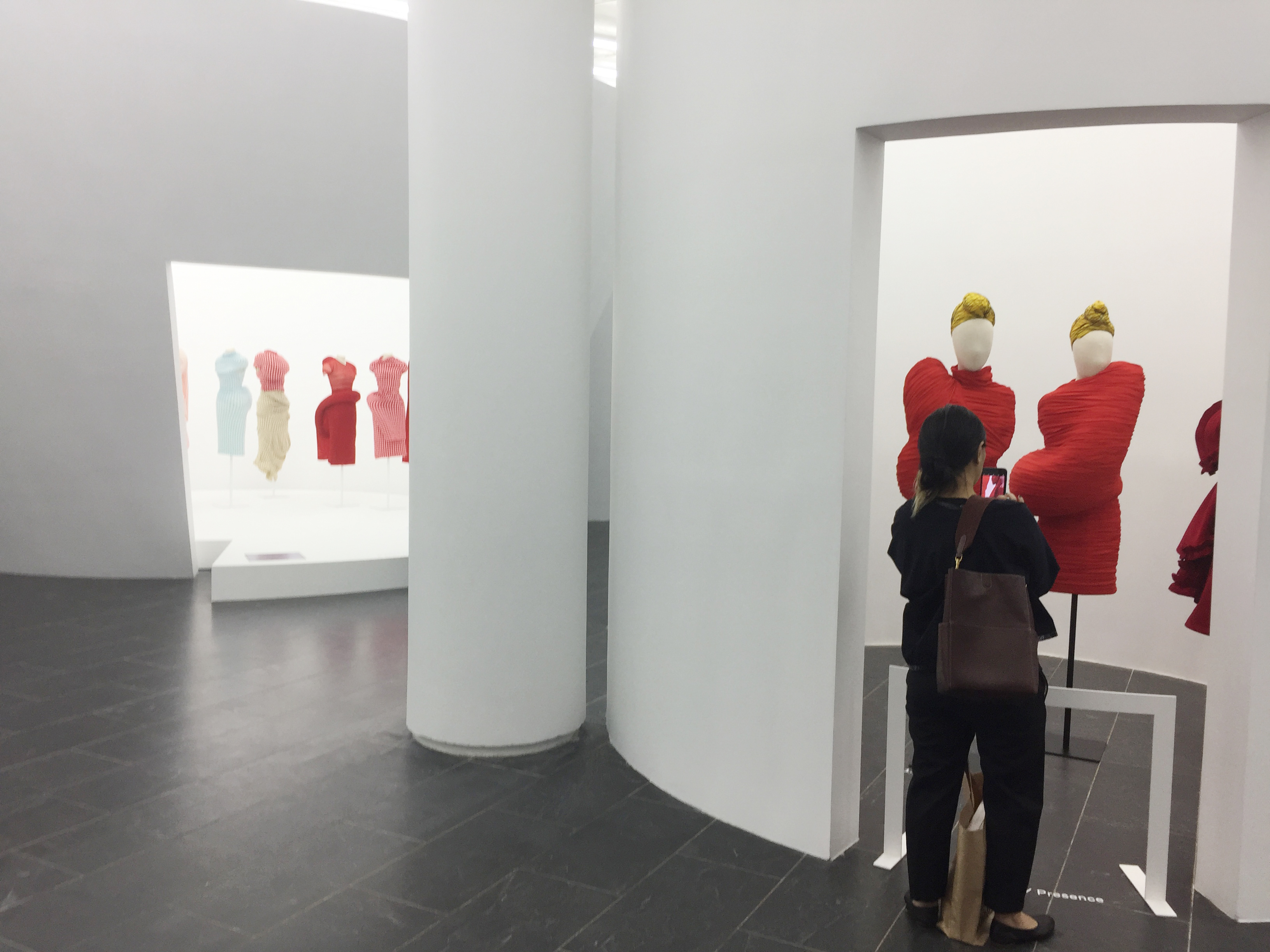 Comme des Garcons exhibition room with sculptural fashion forms